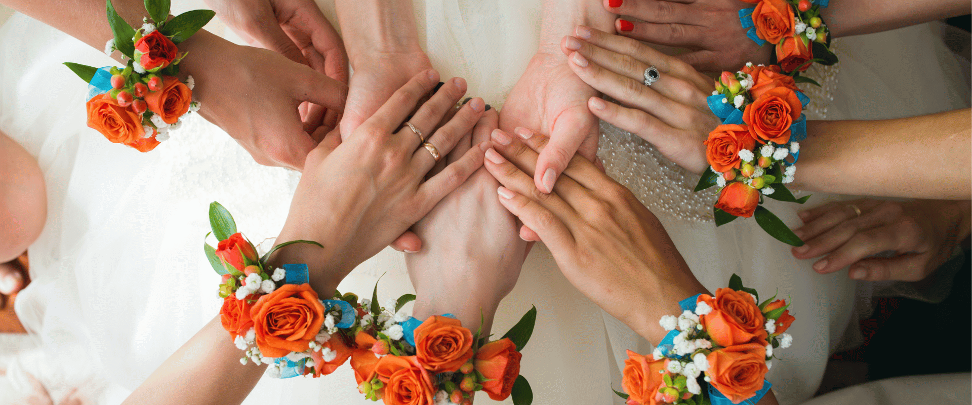 Bridesmaid at an Indian wedding in Singapore wearing floral wrist corsages with bridal party hands together
